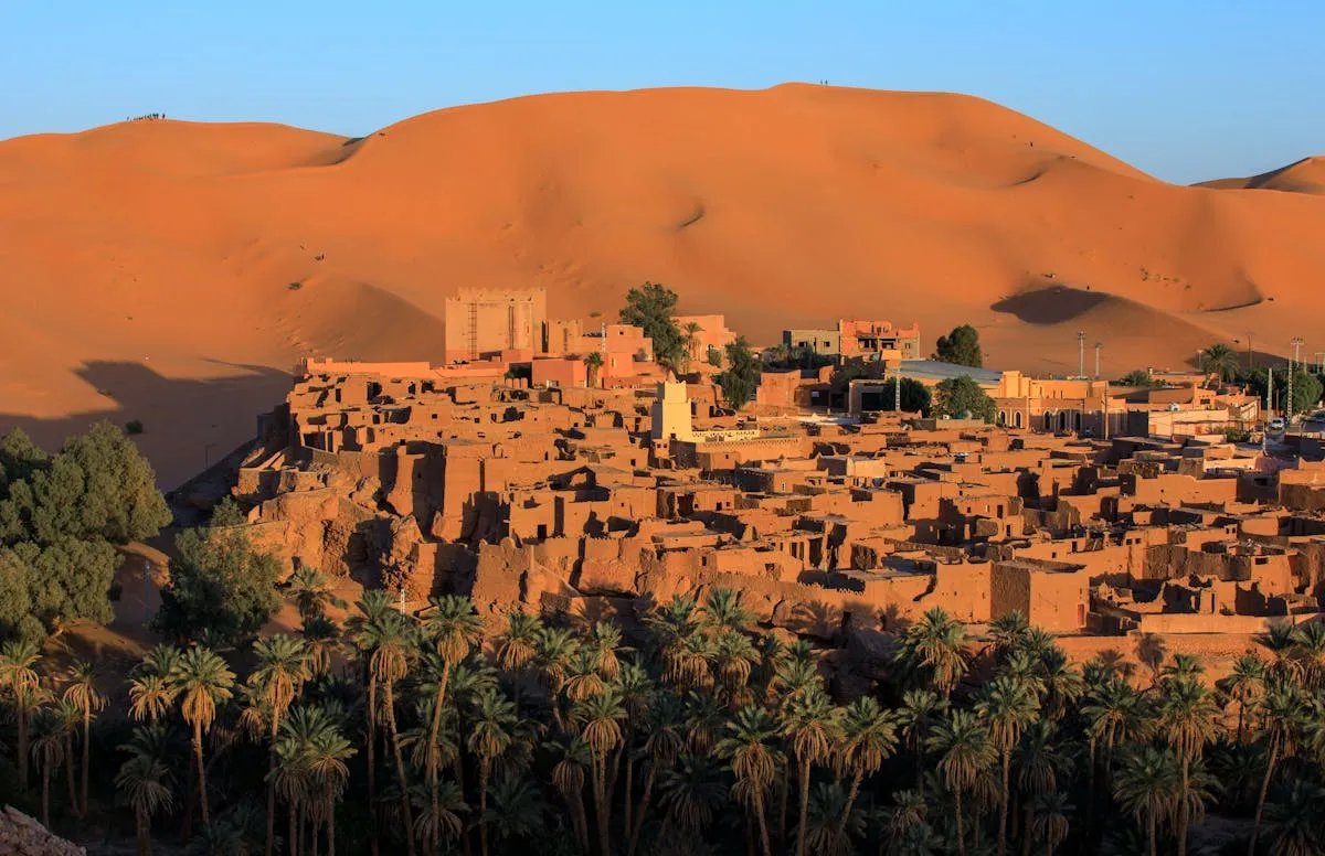 Vue panoramique sur Timimoun, l'oasis rouge du Sahara algérien, avec son ksar en pisé construit au pied des dunes